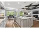 Open concept kitchen with large island and stone countertops and an open flow to dining area and living room at 623 Westfall Way, Chapel Hill, NC 27517