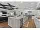 Spacious kitchen with stainless appliances and a large island open to the living room and dining areas at 623 Westfall Way, Chapel Hill, NC 27517