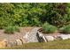 Landscaped yard featuring decorative rocks, mulch, and a variety of plants creating a serene outdoor space at 623 Westfall Way, Chapel Hill, NC 27517