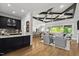 Open-concept living room with coffered ceilings, hardwood floors, and seamless flow to the kitchen at 623 Westfall Way, Chapel Hill, NC 27517