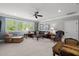 Bright living room with comfortable seating and ample light from the many windows at 623 Westfall Way, Chapel Hill, NC 27517