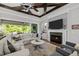 Cozy living room featuring a fireplace, comfortable seating, and access to an outdoor space at 623 Westfall Way, Chapel Hill, NC 27517