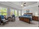 Cozy main bedroom featuring tray ceilings, ample natural light, and comfortable furniture at 623 Westfall Way, Chapel Hill, NC 27517