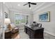 Comfortable office featuring a dark wood desk, leather chair, and natural light from the window at 623 Westfall Way, Chapel Hill, NC 27517