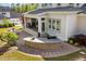Outdoor kitchen with bar, brick surround, a built-in grill and access to an outdoor entertainment area at 623 Westfall Way, Chapel Hill, NC 27517