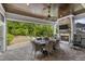 Well-appointed covered patio with a stone fireplace, TV, ceiling fan, and dining area for outdoor entertainment at 623 Westfall Way, Chapel Hill, NC 27517