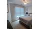 Bright bedroom features a window with blinds, plush carpeting, and a comfortable bed at 631 Springfork Dr, Cary, NC 27513