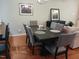 Cozy dining area with dark wood table, cushioned chairs and decorative accents on walls at 631 Springfork Dr, Cary, NC 27513
