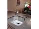 Modern kitchen sink with gray countertops, stainless steel faucet and vase of flowers for a touch of elegance at 631 Springfork Dr, Cary, NC 27513