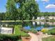 Scenic view of the lake, surrounded by lush landscaping and charming homes at 631 Springfork Dr, Cary, NC 27513