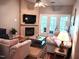 Cozy living room with fireplace and french doors leading to the balcony at 631 Springfork Dr, Cary, NC 27513