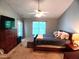 Spacious main bedroom features a ceiling fan, a cozy bed, a TV, and access to the outdoors at 631 Springfork Dr, Cary, NC 27513
