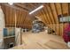 Spacious attic with shelving and lighting; perfect for organized storage and seasonal items at 6500 Bass Mountain Rd, Snow Camp, NC 27349
