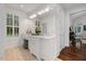 Elegant bathroom featuring a white vanity, marble countertop, and a window with plantation shutters at 6500 Bass Mountain Rd, Snow Camp, NC 27349