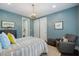This blue bedroom features a unique antler chandelier and cozy armchair, perfect for relaxation at 6500 Bass Mountain Rd, Snow Camp, NC 27349