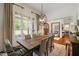 Dining room features a rustic wood table, a modern chandelier, and large windows at 6500 Bass Mountain Rd, Snow Camp, NC 27349