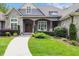 Stunning stone home with manicured landscaping and a walkway leading to the front door at 6500 Bass Mountain Rd, Snow Camp, NC 27349