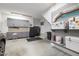 Well-organized garage with gray cabinets, black refrigerator, and ample storage space at 6500 Bass Mountain Rd, Snow Camp, NC 27349
