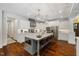 Well-appointed kitchen with a large island, bar stool seating and stainless steel appliances at 6500 Bass Mountain Rd, Snow Camp, NC 27349