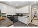 Bright laundry room with modern appliances, white cabinets, dark countertops and tile floors at 6500 Bass Mountain Rd, Snow Camp, NC 27349