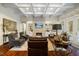 Spacious living room with lots of natural light, fireplace and coffered ceilings at 6500 Bass Mountain Rd, Snow Camp, NC 27349