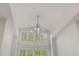 Bright living room featuring a decorative chandelier and clerestory windows with plantation shutters at 6500 Bass Mountain Rd, Snow Camp, NC 27349