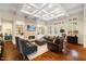 Bright and airy living room featuring coffered ceilings, a fireplace, and built-in shelving at 6500 Bass Mountain Rd, Snow Camp, NC 27349