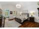 Elegant main bedroom featuring a vaulted ceiling, chandelier, and French doors to the outside at 6500 Bass Mountain Rd, Snow Camp, NC 27349