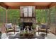 Relax on this screened porch with a stone fireplace and views of the backyard pool at 6500 Bass Mountain Rd, Snow Camp, NC 27349