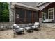 Inviting stone patio with chairs and a screened-in porch, perfect for outdoor relaxation at 6500 Bass Mountain Rd, Snow Camp, NC 27349