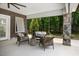 Relax in the outdoor living area on this covered patio with views of a wooded backyard at 6500 Bass Mountain Rd, Snow Camp, NC 27349