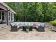 Generous patio with a stylish sectional, fire pit, and landscaping at 6500 Bass Mountain Rd, Snow Camp, NC 27349
