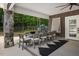 Enjoy outdoor dining on this covered patio with stone column accents and views of a private backyard at 6500 Bass Mountain Rd, Snow Camp, NC 27349