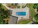 Aerial view of a pristine pool area with lounge chairs, patio furniture, and manicured landscaping at 6500 Bass Mountain Rd, Snow Camp, NC 27349