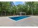Enjoy this backyard pool area with ample seating, a cabana, and privacy fencing at 6500 Bass Mountain Rd, Snow Camp, NC 27349