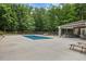 Beautiful backyard pool area with lounge chairs and a covered outdoor dining space at 6500 Bass Mountain Rd, Snow Camp, NC 27349