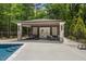 This lovely pool house features both dining and living spaces, perfect for outdoor entertaining at 6500 Bass Mountain Rd, Snow Camp, NC 27349