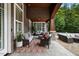 Covered outdoor patio with comfortable seating and stylish rug at 6500 Bass Mountain Rd, Snow Camp, NC 27349