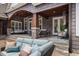 Covered outdoor patio with comfortable seating, ceiling fan and a peaceful porch swing at 6500 Bass Mountain Rd, Snow Camp, NC 27349