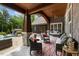 Inviting outdoor patio with stone columns, comfortable seating, and covered porch at 6500 Bass Mountain Rd, Snow Camp, NC 27349