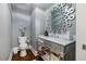 Chic powder room with decorative mirror, marble vanity, and modern fixtures at 6500 Bass Mountain Rd, Snow Camp, NC 27349