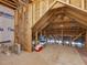 Spacious unfinished attic with exposed rafters, insulation, and plywood flooring at 67 Spring Hollow Ct, Pittsboro, NC 27312