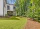 Expansive backyard featuring lush green lawn and a screened porch perfect for outdoor entertaining at 67 Spring Hollow Ct, Pittsboro, NC 27312