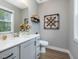 Stylish half-bathroom featuring a modern vanity, decorative mirror, and elegant decor at 67 Spring Hollow Ct, Pittsboro, NC 27312