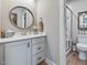 Bright bathroom with a vanity and a view into the tiled walk-in shower with glass door at 67 Spring Hollow Ct, Pittsboro, NC 27312