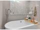 Bathroom featuring a soaking tub, a frameless glass shower, neutral tile and recessed lighting at 67 Spring Hollow Ct, Pittsboro, NC 27312