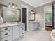 Bathroom featuring double sinks, large mirrors, white countertops and decorative fixtures at 67 Spring Hollow Ct, Pittsboro, NC 27312