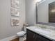 Elegant half-bathroom with granite countertop, updated sink, and sophisticated decor at 67 Spring Hollow Ct, Pittsboro, NC 27312