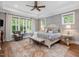 Bedroom featuring tray ceilings, hardwood floors, natural light, and decorative furnishings at 67 Spring Hollow Ct, Pittsboro, NC 27312