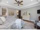 Bedroom featuring hardwood floors, tray ceilings, an accent chair and decorative furnishings at 67 Spring Hollow Ct, Pittsboro, NC 27312